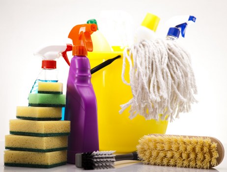 Safety-focused cleaner preparing equipment with protective gear